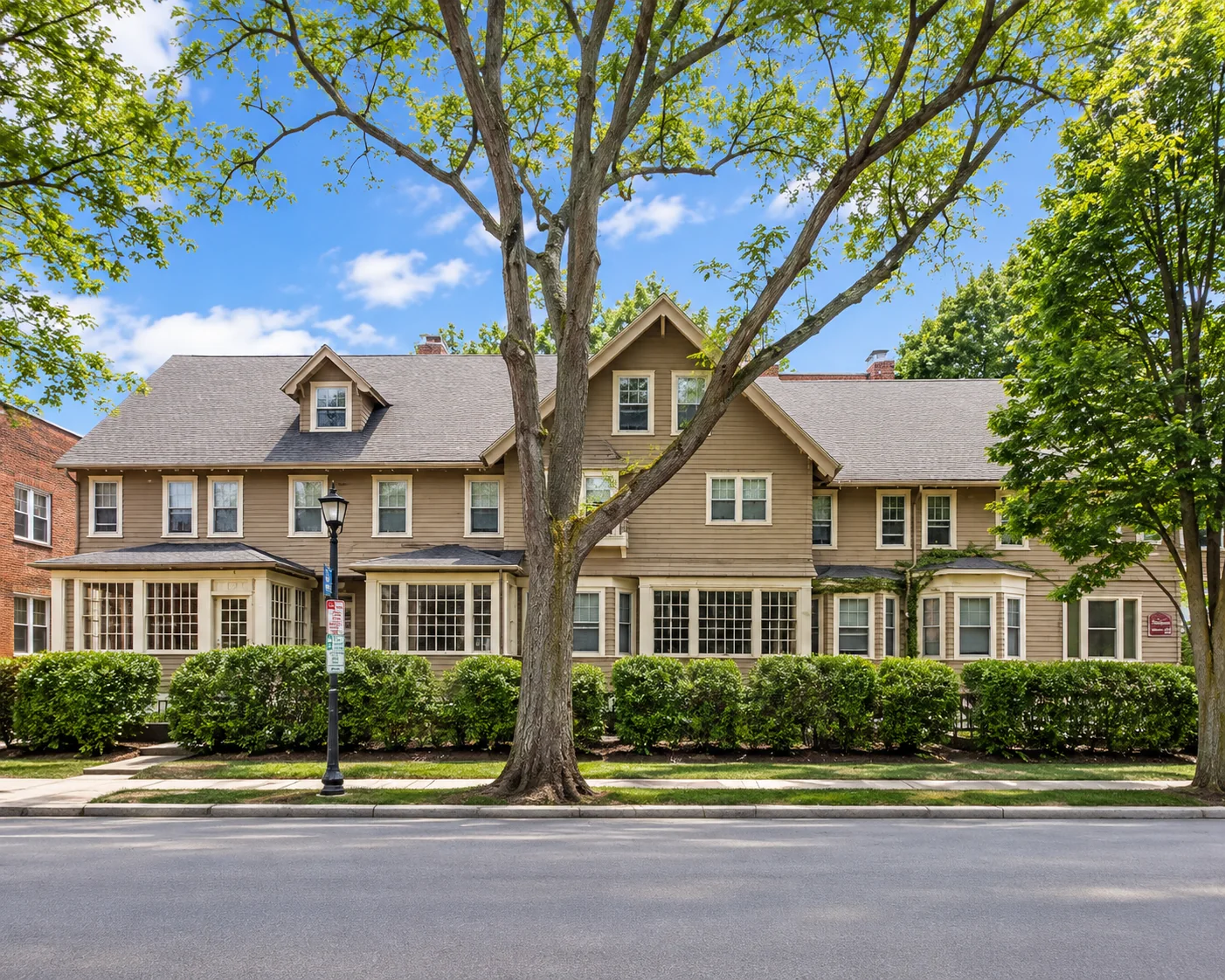 Row of connected residences behind a trimmed hedge at 246-254 Park Ave. in Rochester, NY