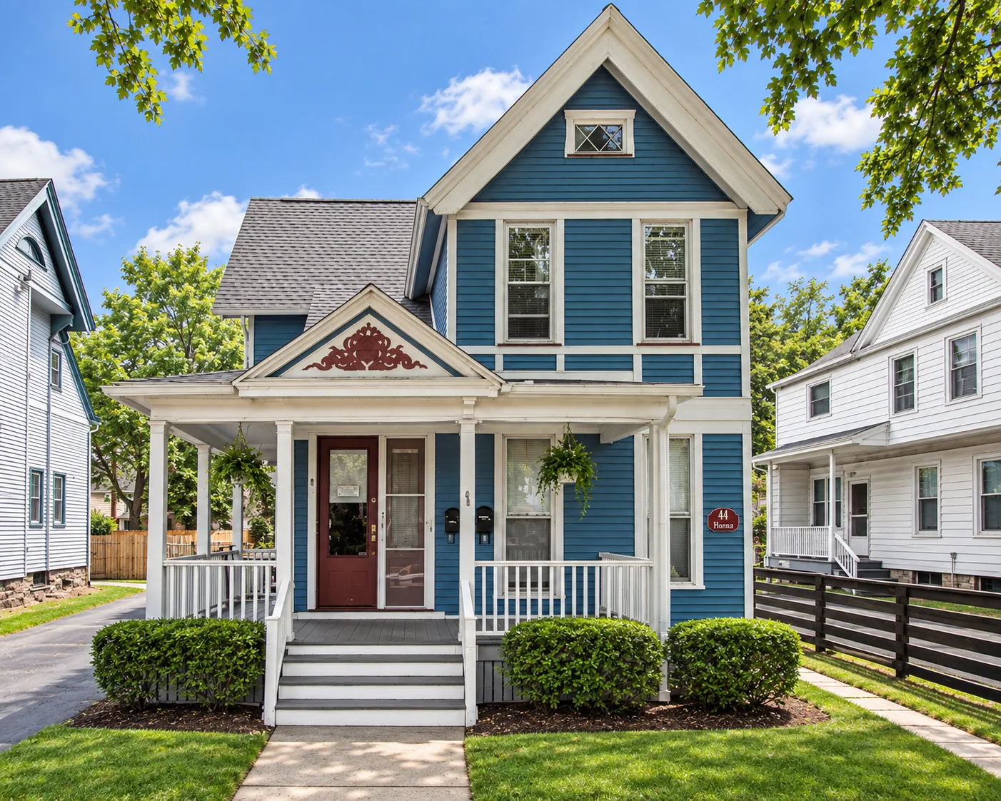 Blue Victorian multi-family house with a white front porch at 44 Brighton St. in Rochester, NY