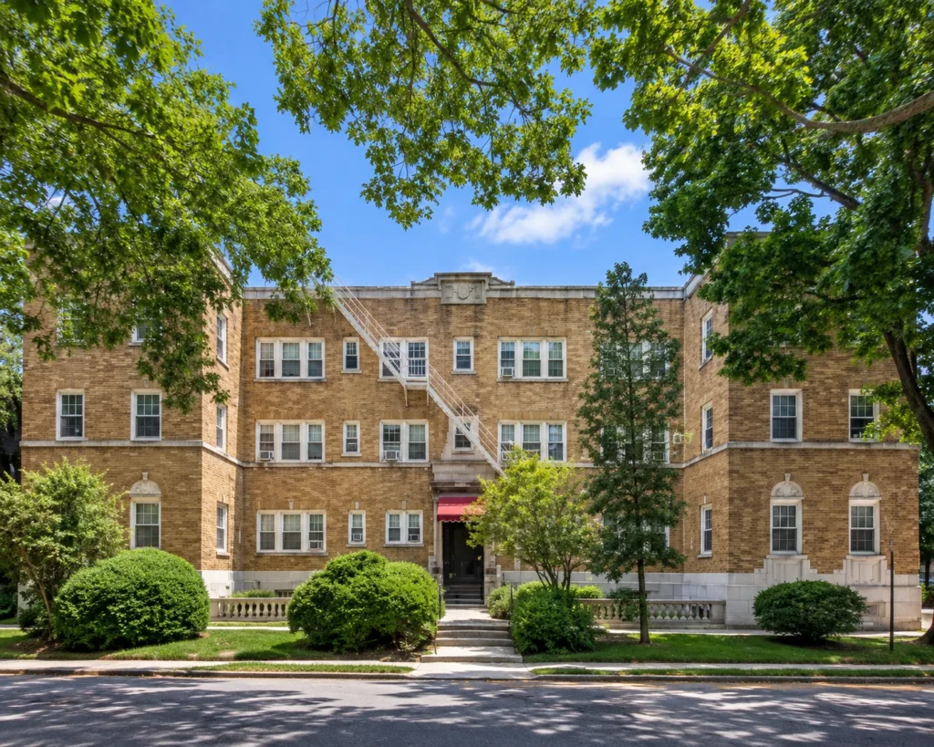 Berkeley Court, a tan-brick apartment building framed by mature trees at 214 Berkeley St. in Rochester, NY