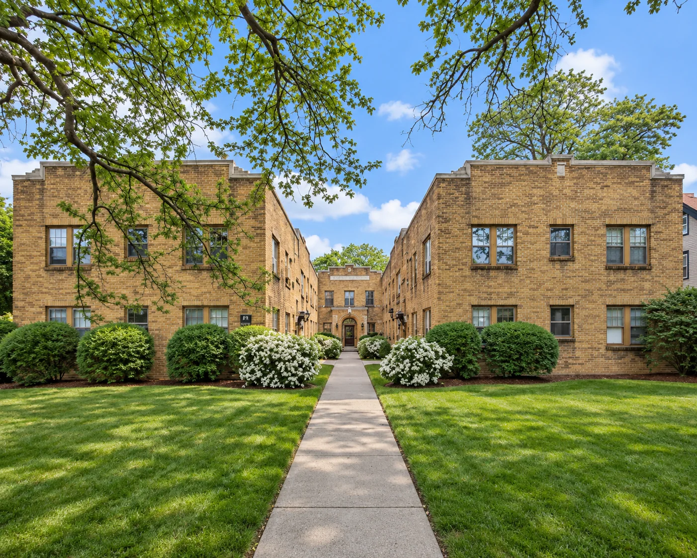 Oliver Court, twin tan-brick apartment buildings around a landscaped courtyard at 94 Oliver St. in Rochester, NY