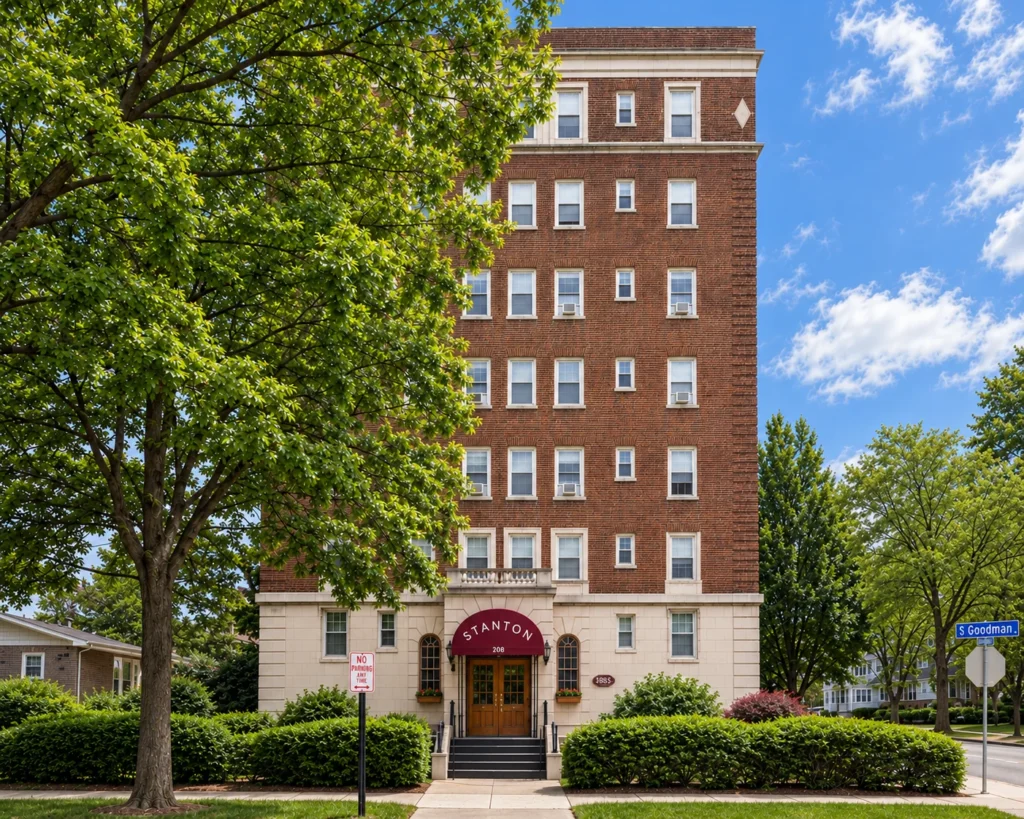 The Stanton, a tall red-brick apartment building with a limestone base at 240 S. Goodman St. in Rochester, NY