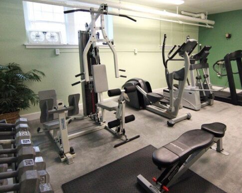 Fitness center furnished with free weights and excercise equipment